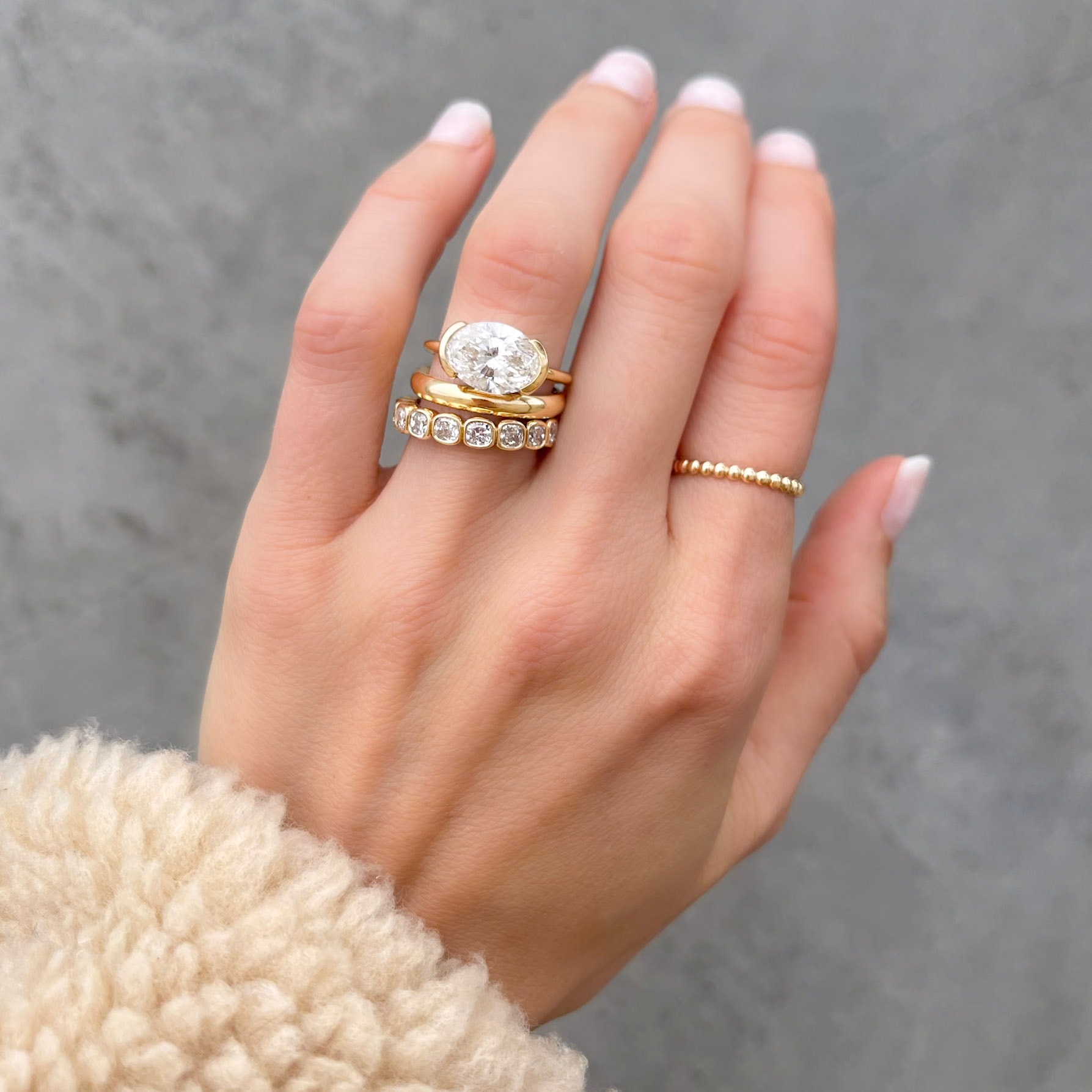East West Half Bezel Solitaire Engagement Ring With Oval Cut Diamond