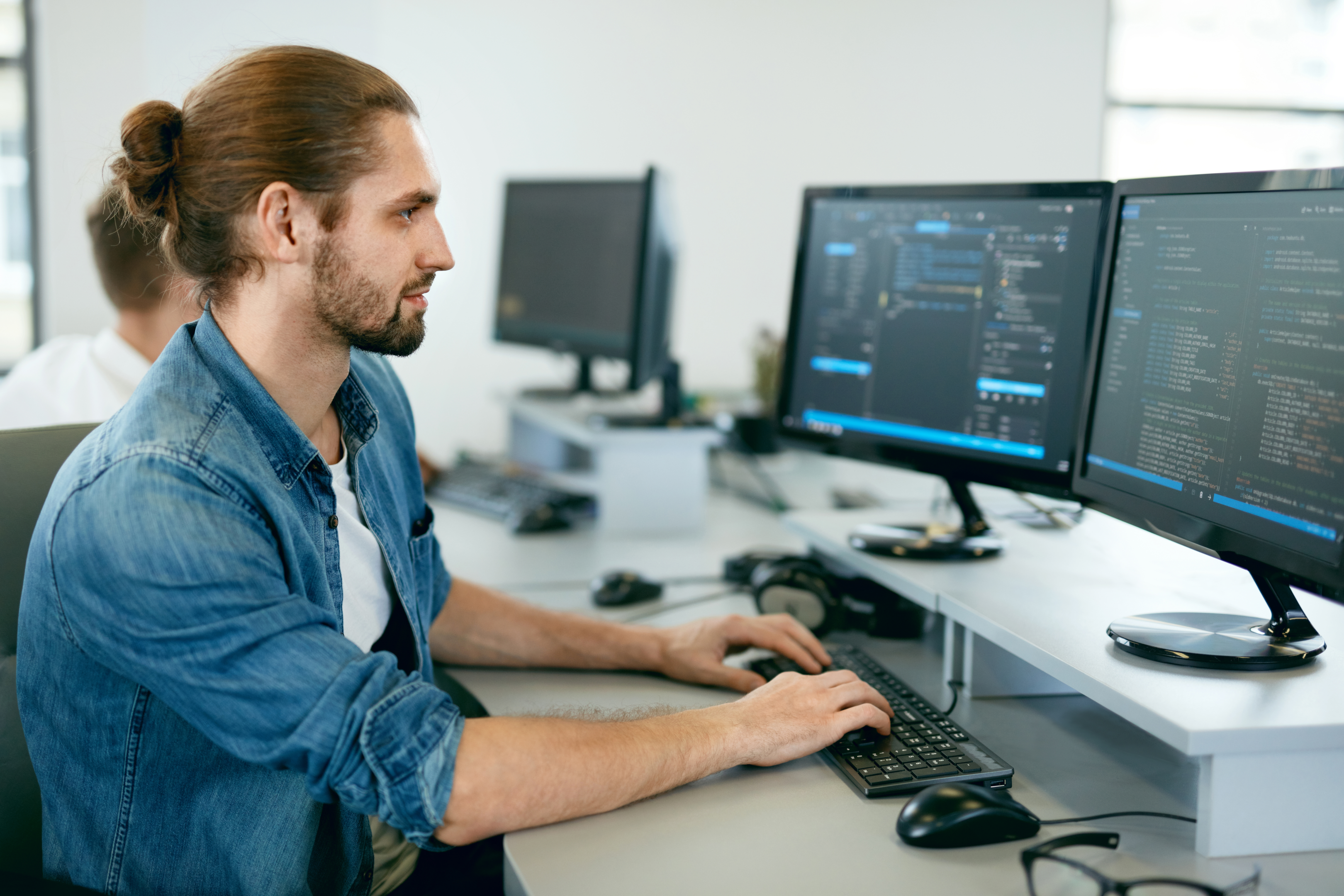 Male programmer writing Python code