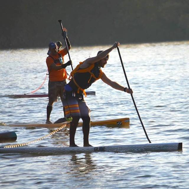 stand up paddle board racing on a race board