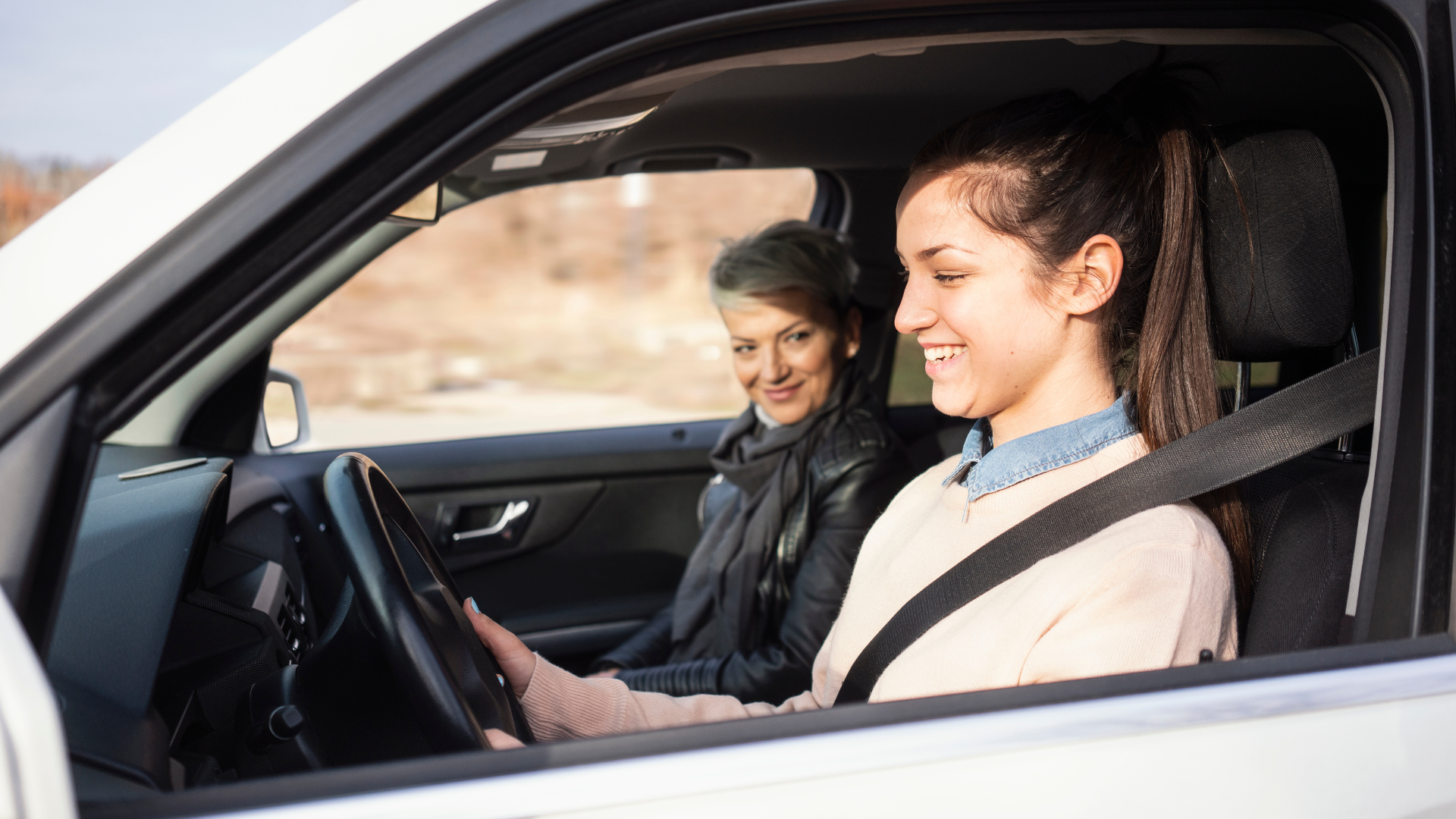 girl learning to drive in a car