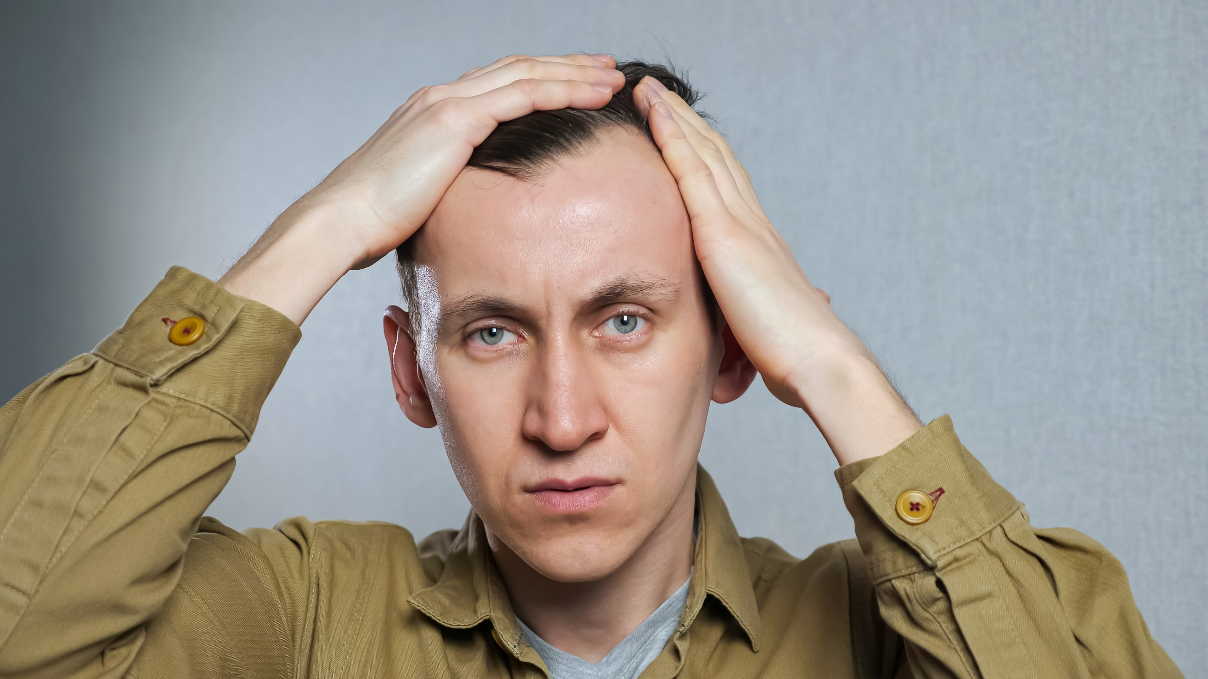 A receding hairline is a common sign of thinning hair.