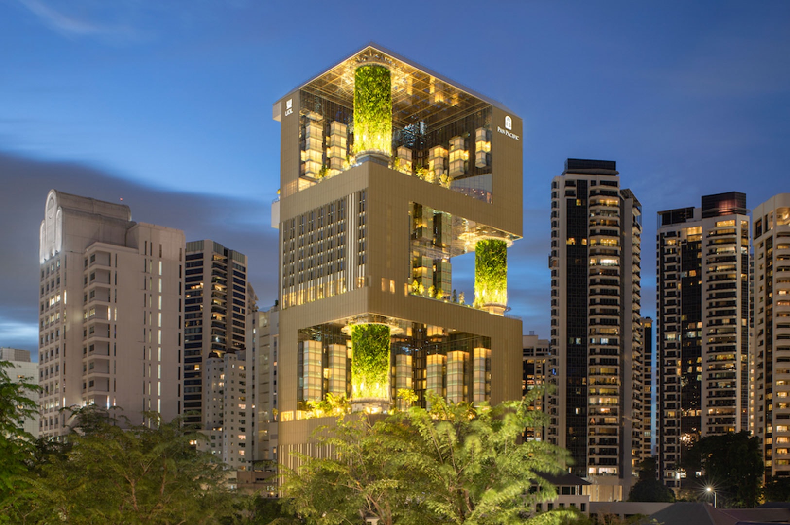 Night view of Pan Pacific Orchard, a modern high-rise with illuminated sky terraces and lush vertical gardens.