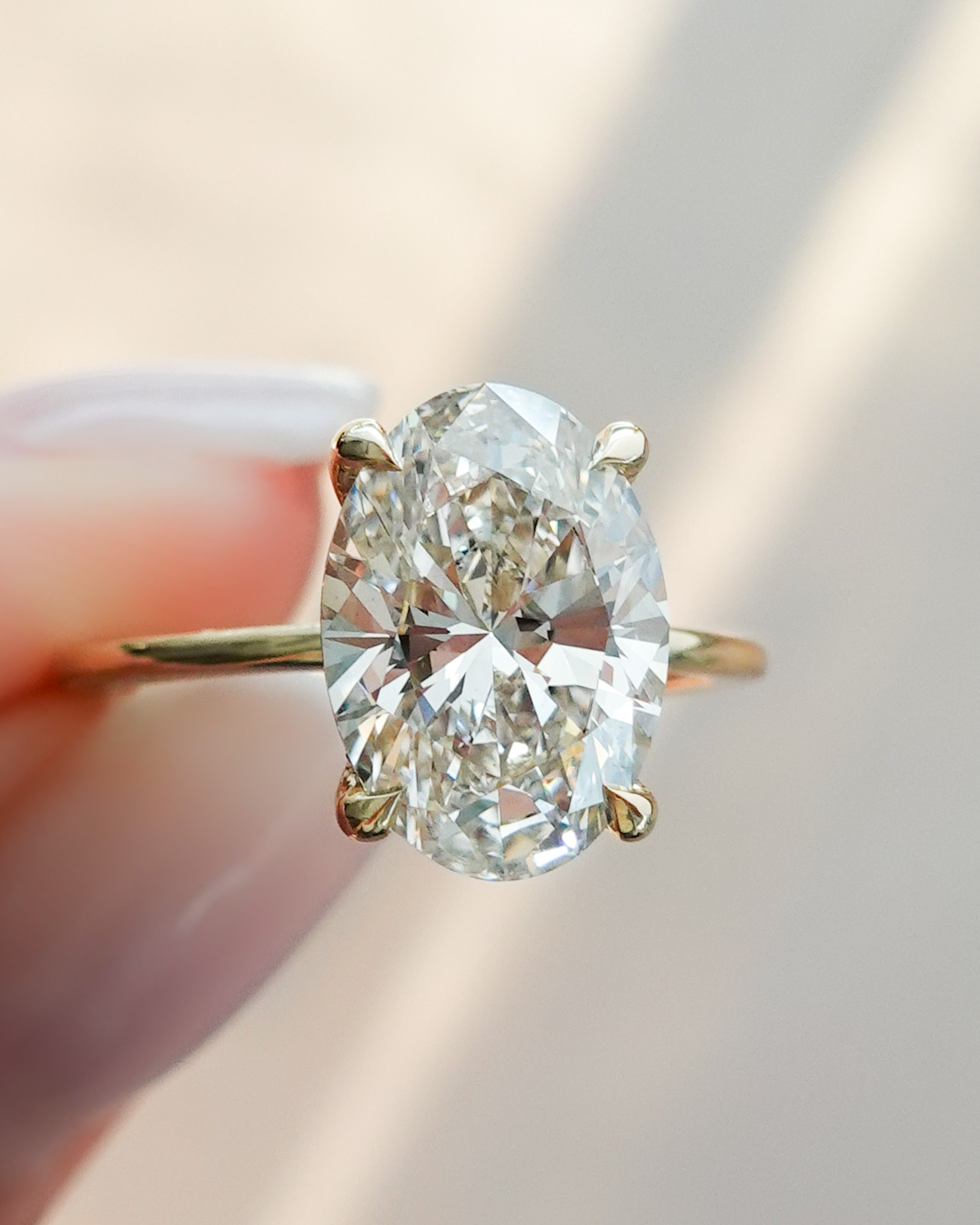 Thin + Simple Solitaire Engagement Ring With Oval Cut Diamond