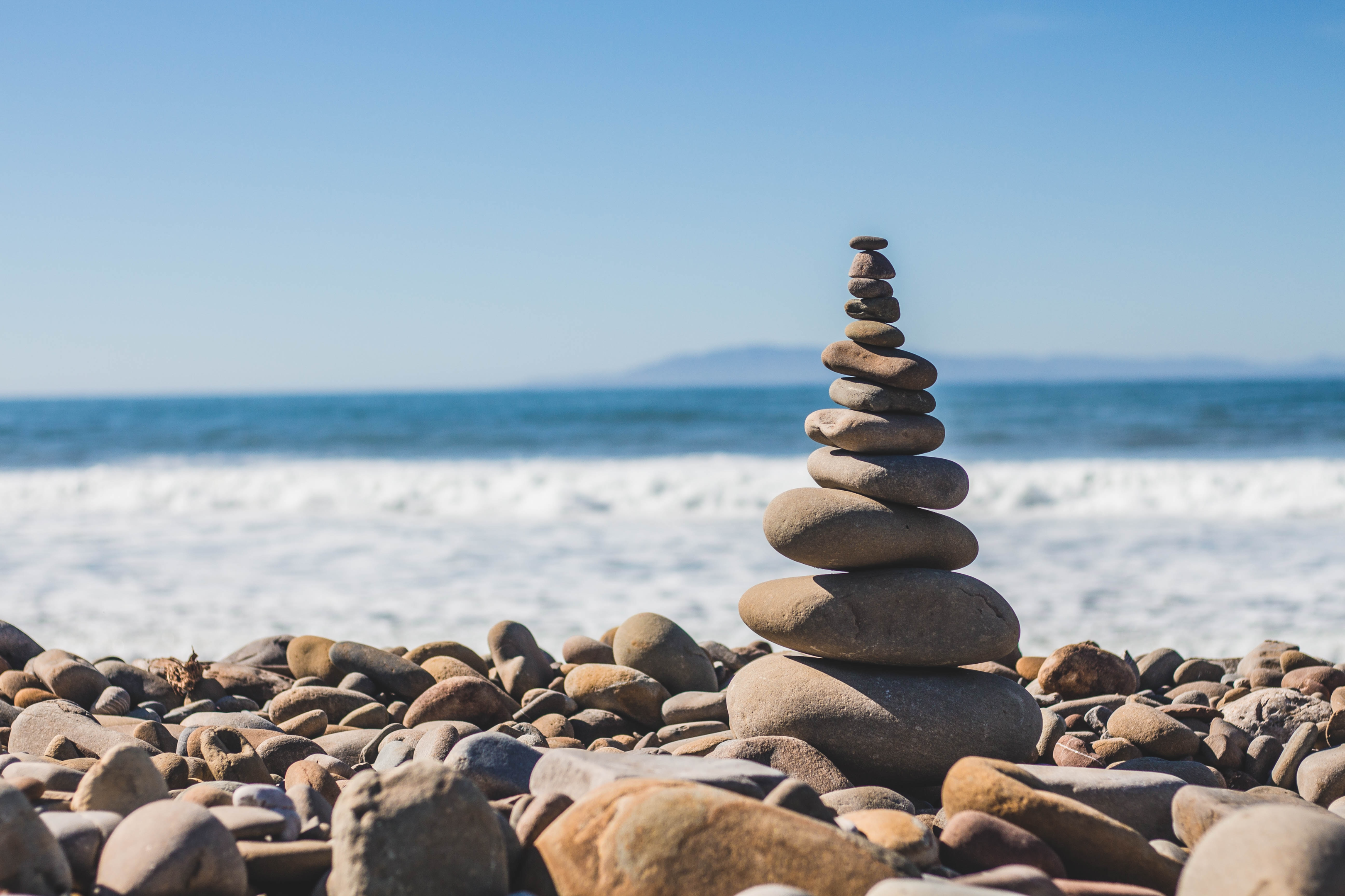 stones balanced on top of each other in balance by the seashore