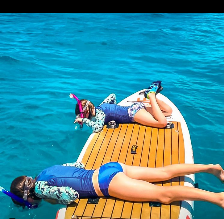 two girls on a paddle board
