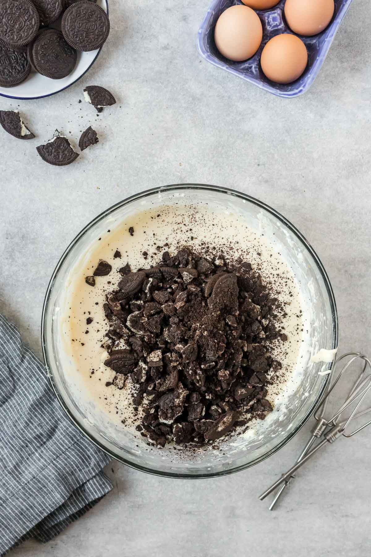 Oreo cookie crumbs stirred into cheesecake batter