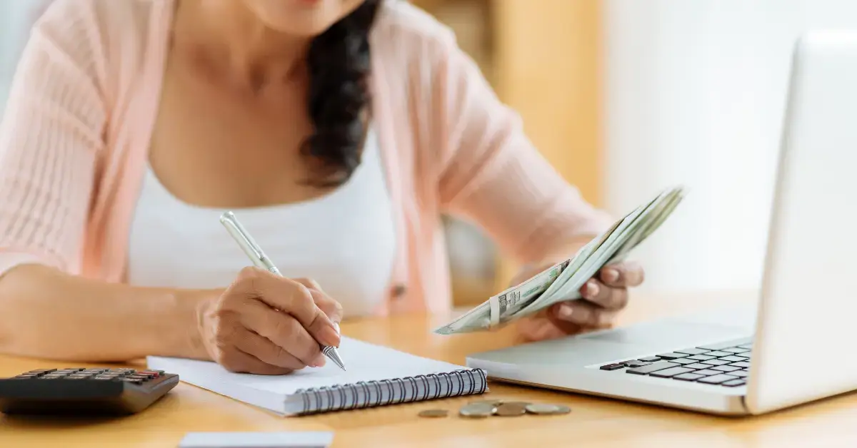 Woman planning taxes and monthly business expenses after learning how to calculate cash flow.