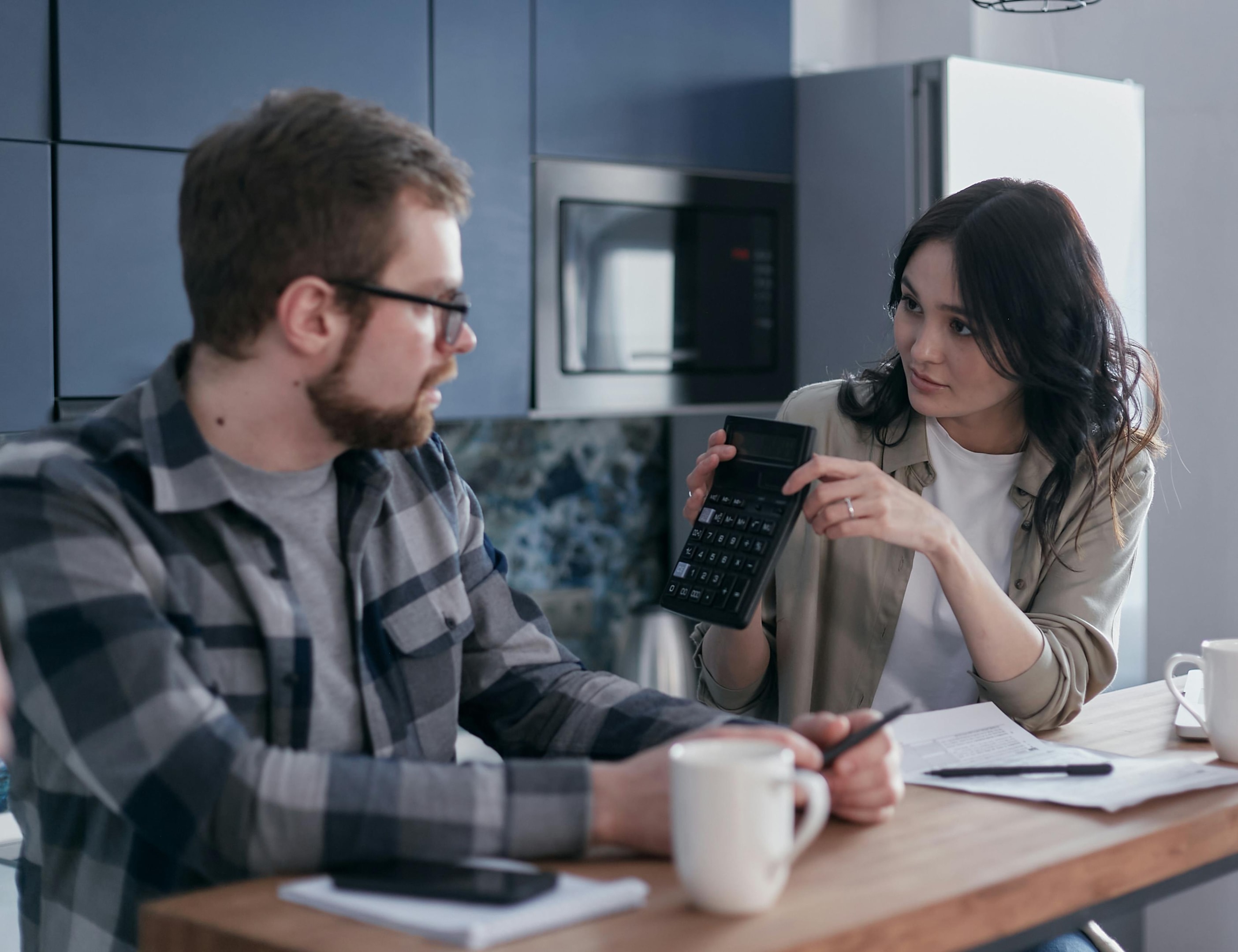 couple discussing expenses over cups of coffee