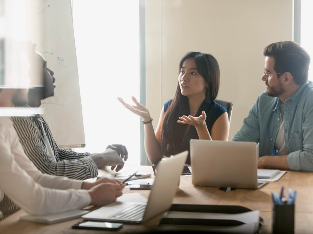 A divorcing couple having a mediation meeting with their attorneys