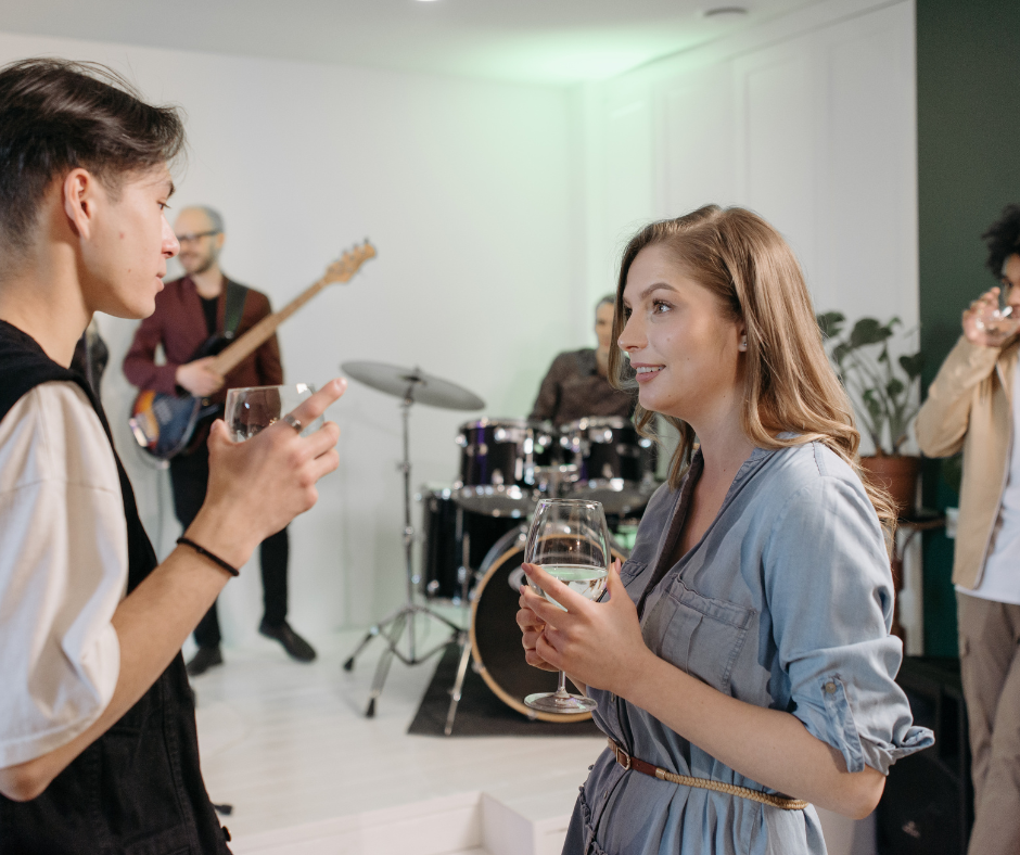 A person holding a glass of alcohol while looking at a pill bottle, representing the struggle of how to get sober from alcohol and the importance of choosing the right treatment approach.