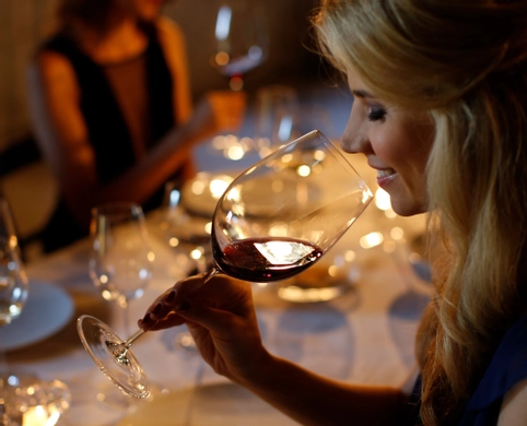 Woman testing the nose of a red wine