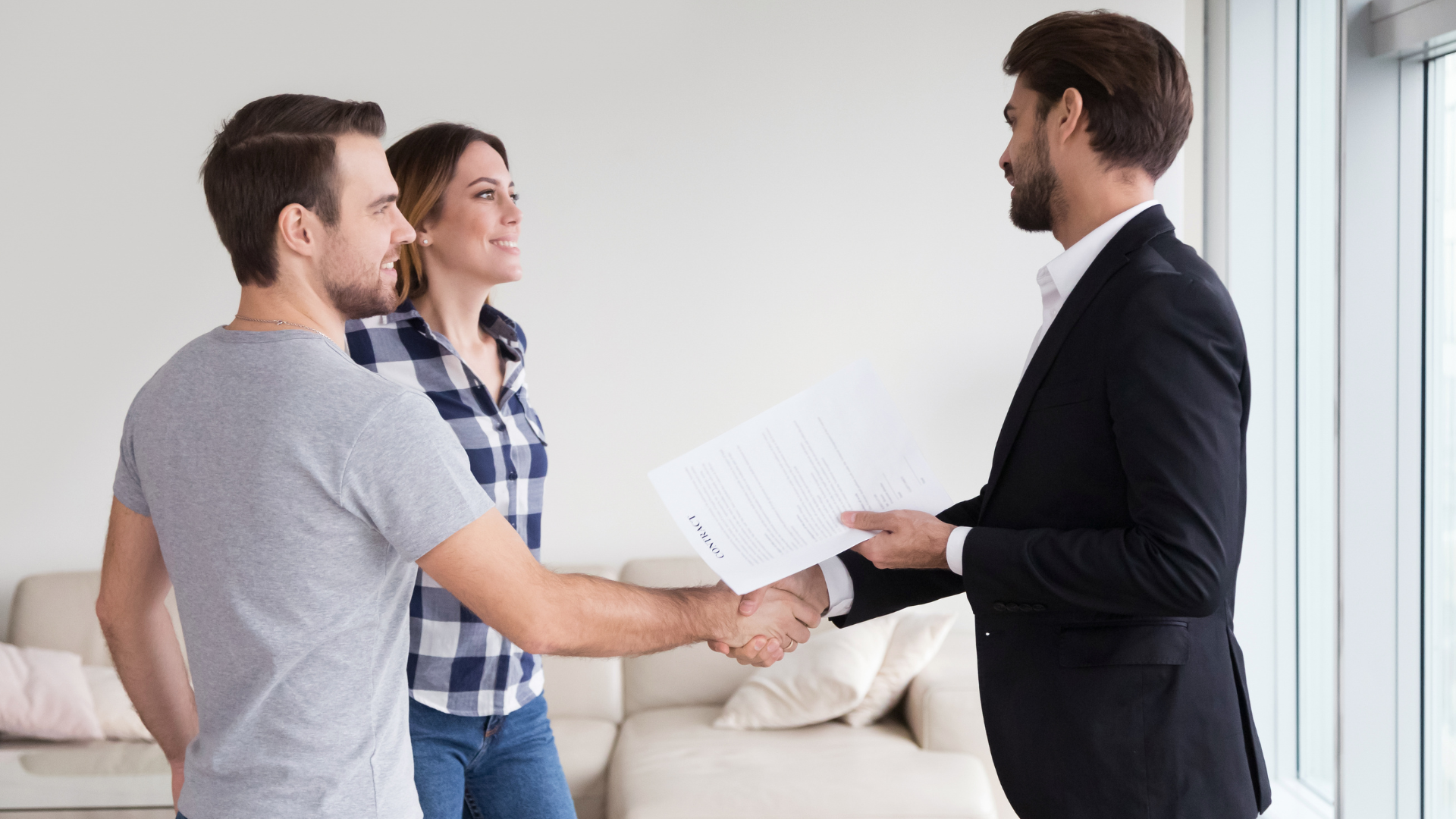 Investment Property - A couple has successfully signed a real estate investment project and shaking hands with the broker
