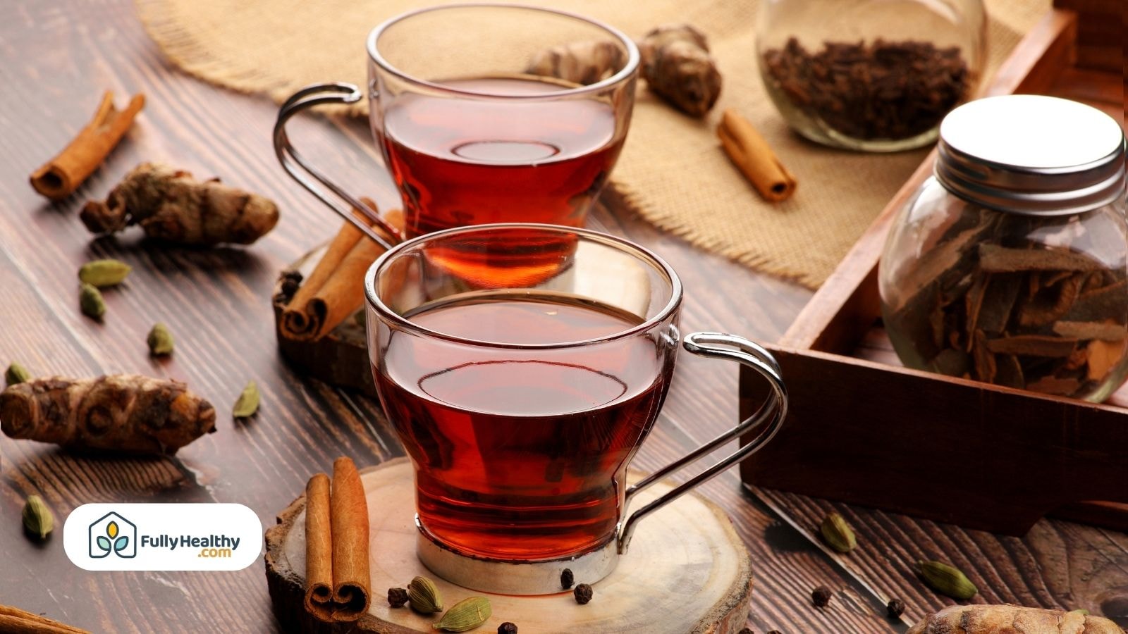 Glass cups of spiced tea with cinnamon cardamom and turmeric pieces