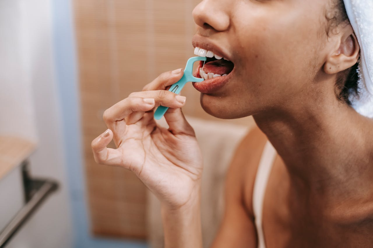 Woman flossing teeth