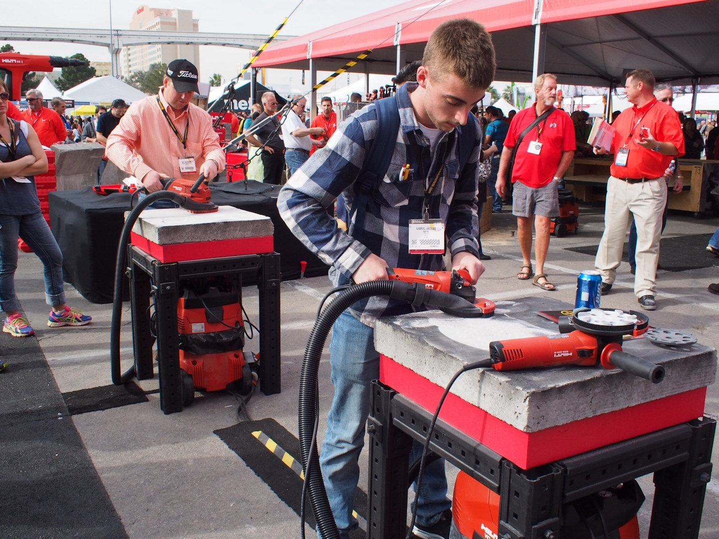 Industry-Specific Trade Show Attire – People Testing Power Tools At A Construction Expo