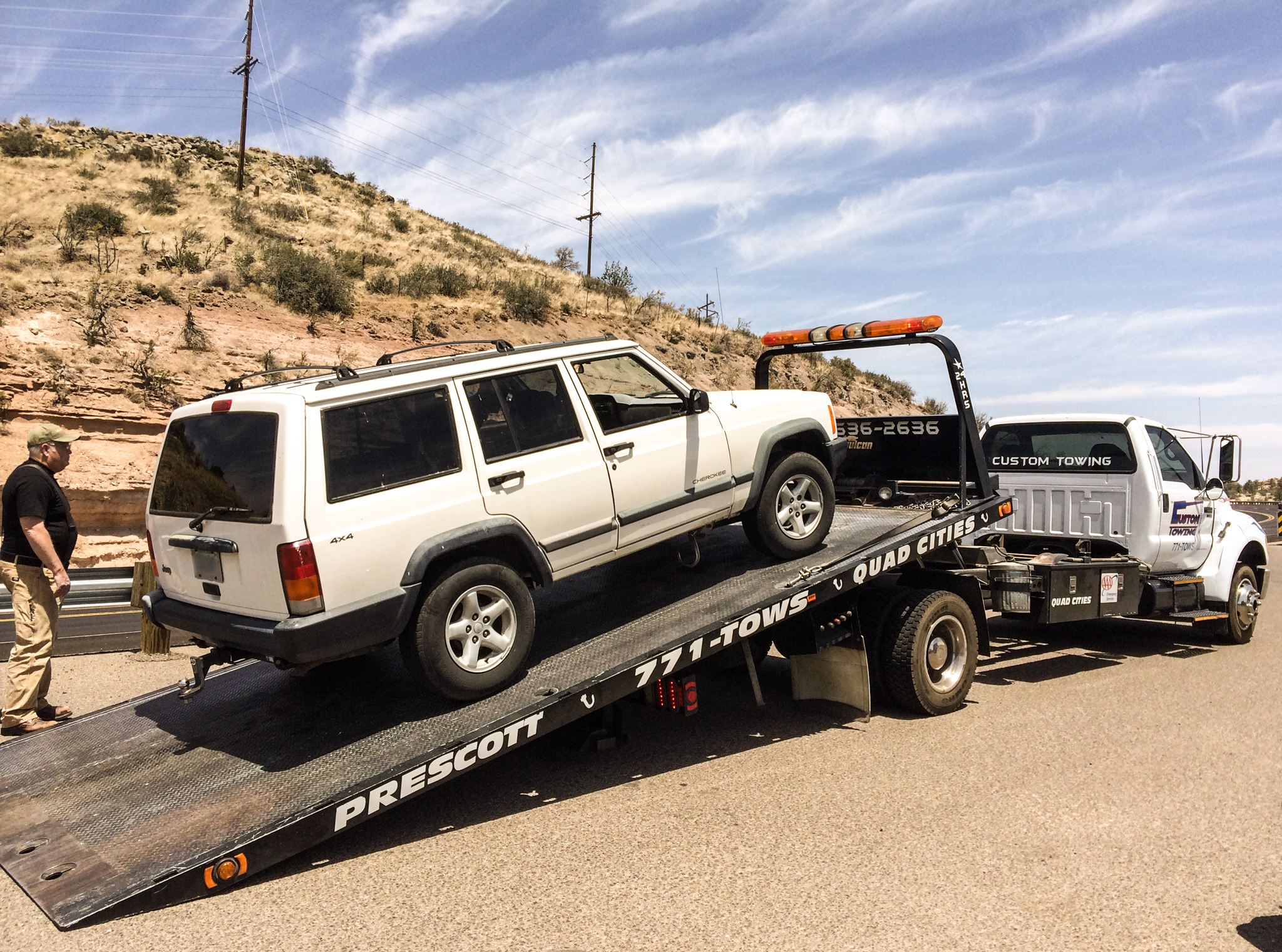 A car being towed away by a tow truck