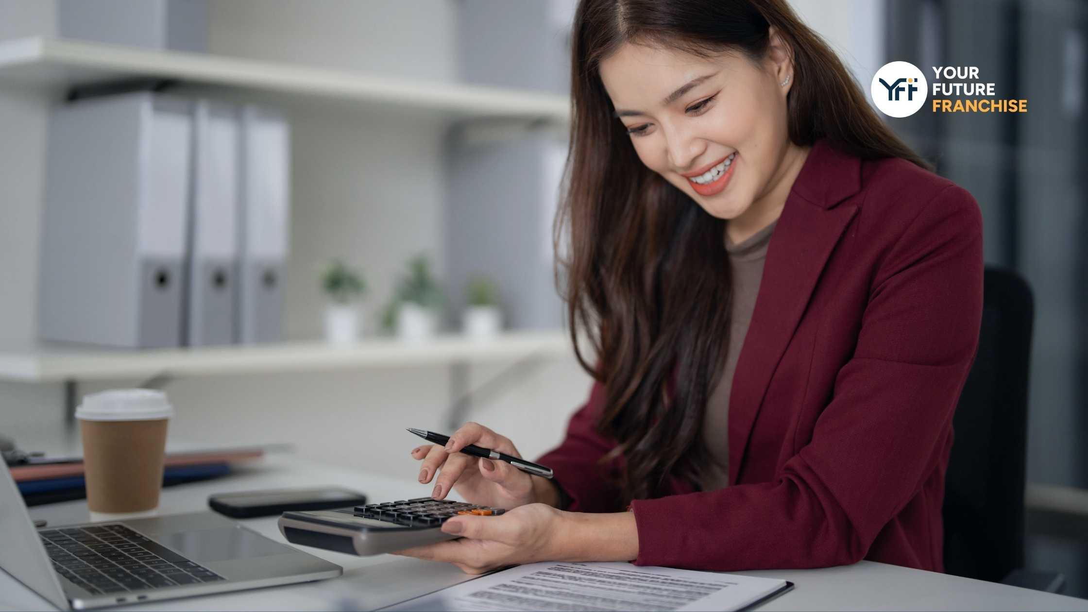 A women smiling and calculating finances