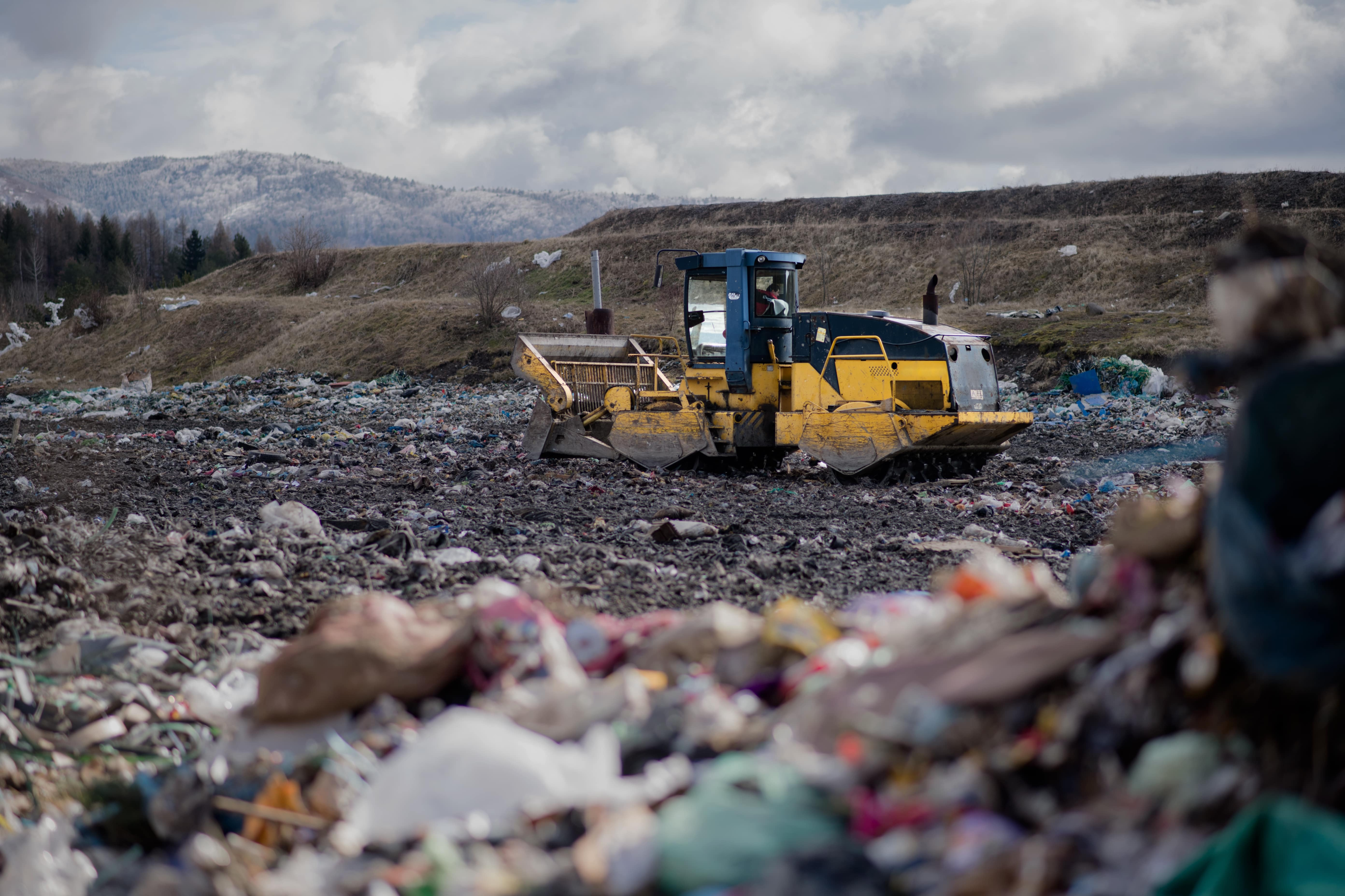 Household waste being processed at landfill site