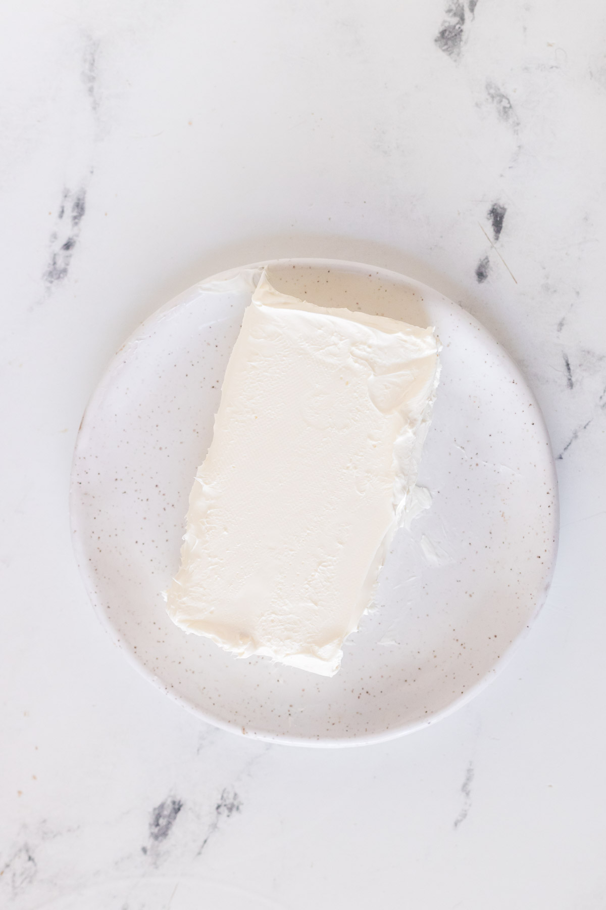 block of cream cheese on a plate