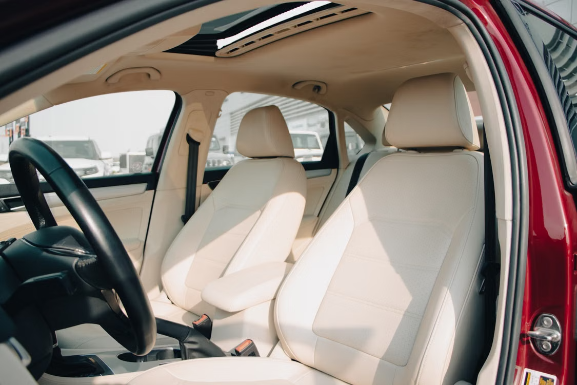 Spacious car interior featuring elegant cream leather seats