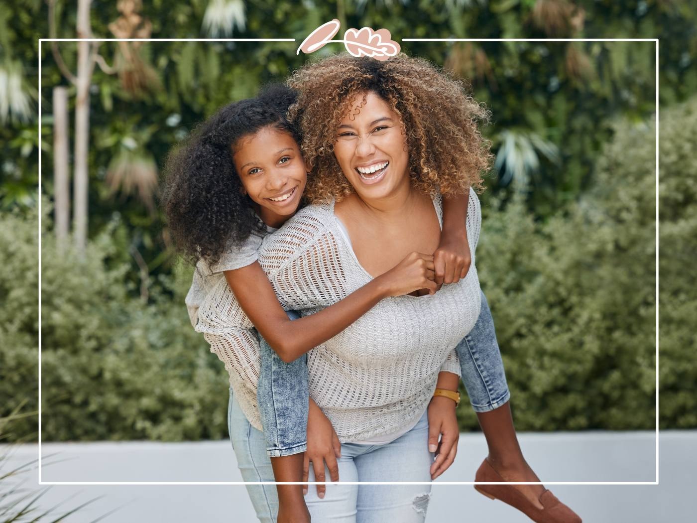 Mother and daughter having fun outdoors, daughter piggybacking. A joyful and carefree moment shared between them.