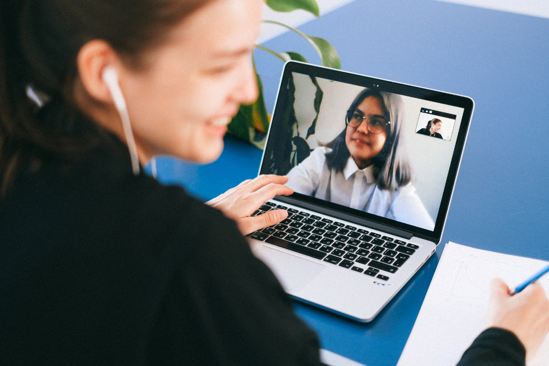 Remote meeting between founder and offshore team member on laptop