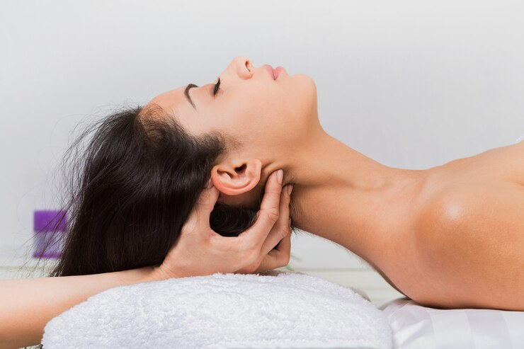 Woman having ear massage 