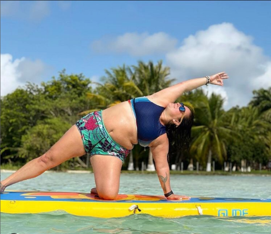 sup yoga pose on a paddle board