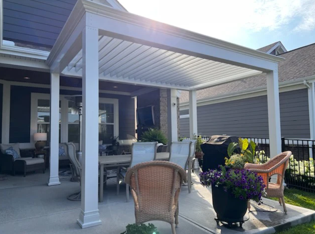 Beautiful white pergola with beam anchored on patio