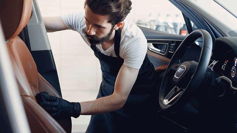 a man cleaning a car seat