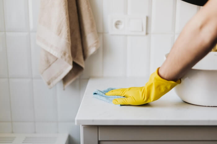 Gloved hand cleaning vacation rental properties