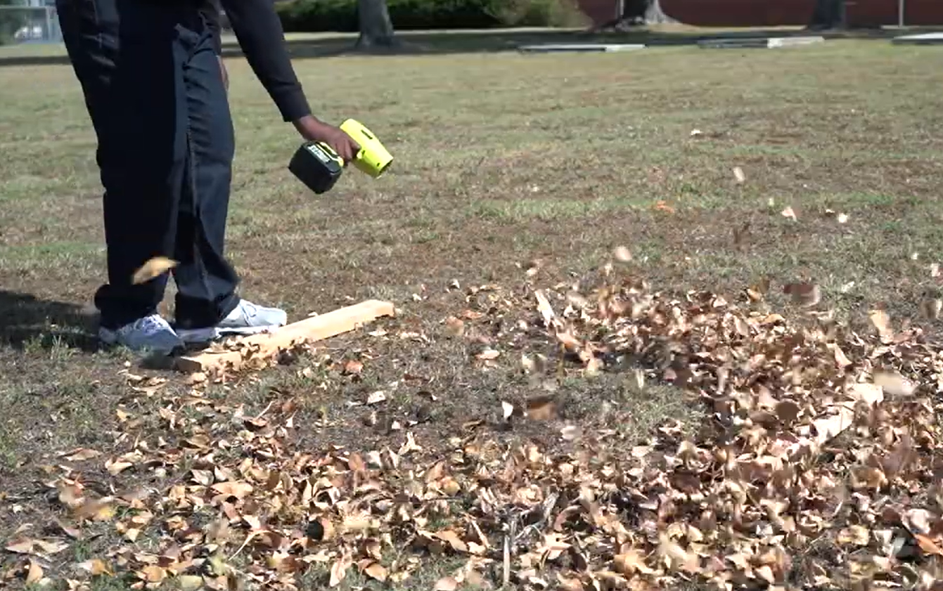 clearing leaves using Sakerplus cordless leaf blower