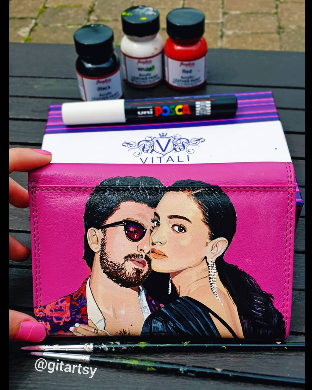 Hand painted pink leather wallet with portraits of Deepika Padukone and Ranger Singh 