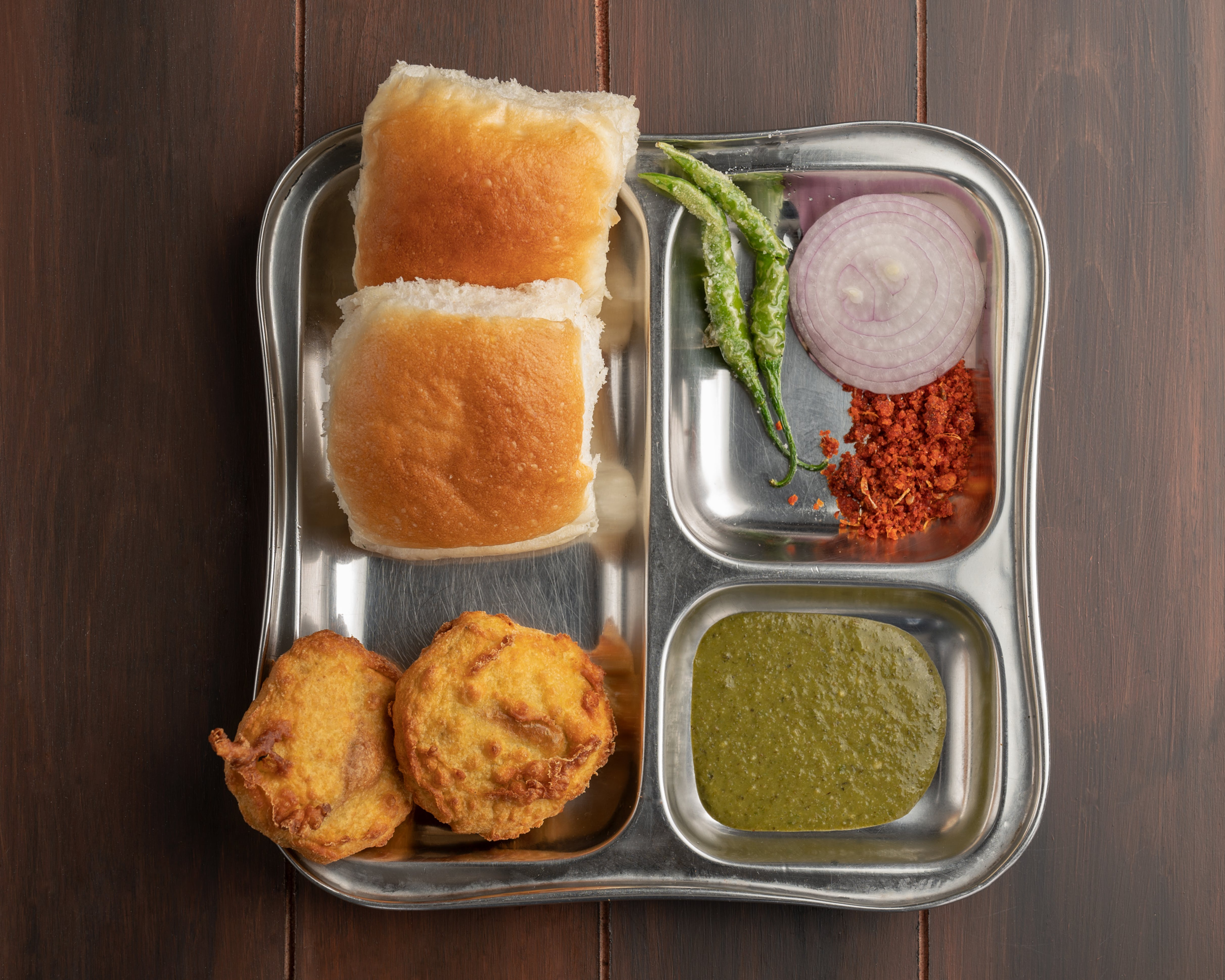 Vada Pav - Traditional Indian street food, consisting of a spicy potato patty served with a bun.