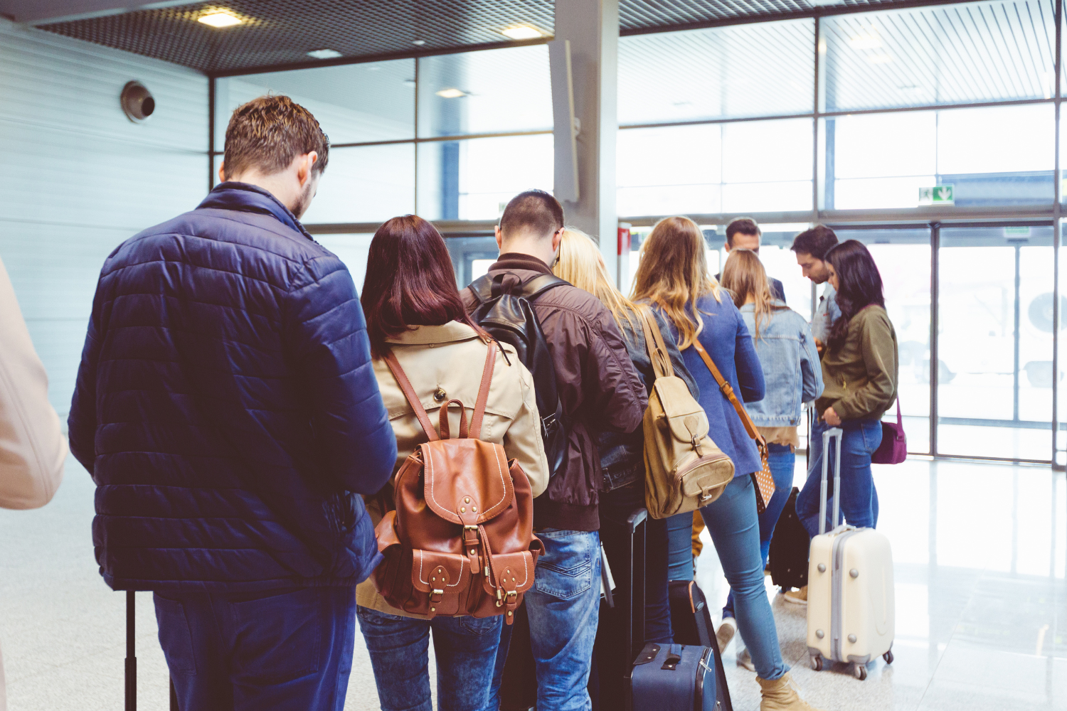 Passengers standing in queue waiting to board their flight