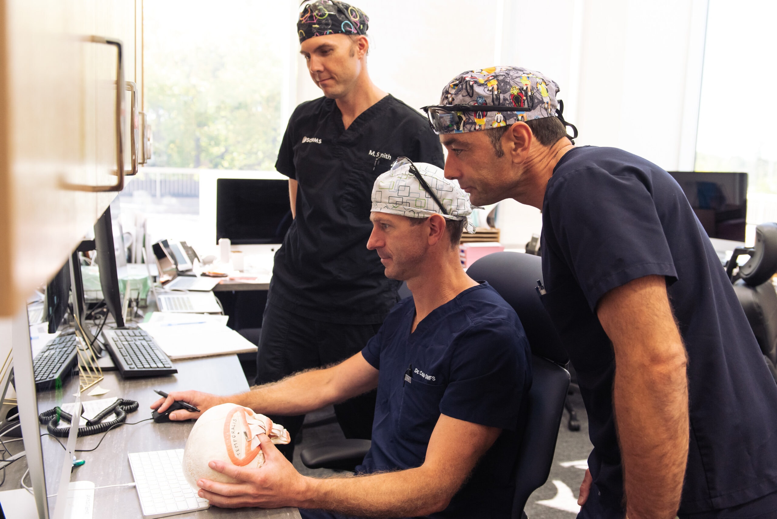 Oral surgeons preparing for removal