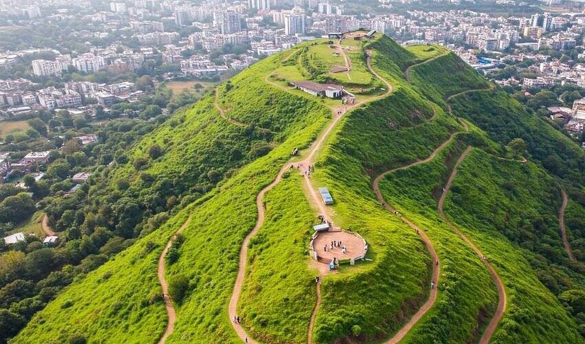 Scenic view of Baner Hill with walking trails, lush greenery, and a clear skyline in Pune.