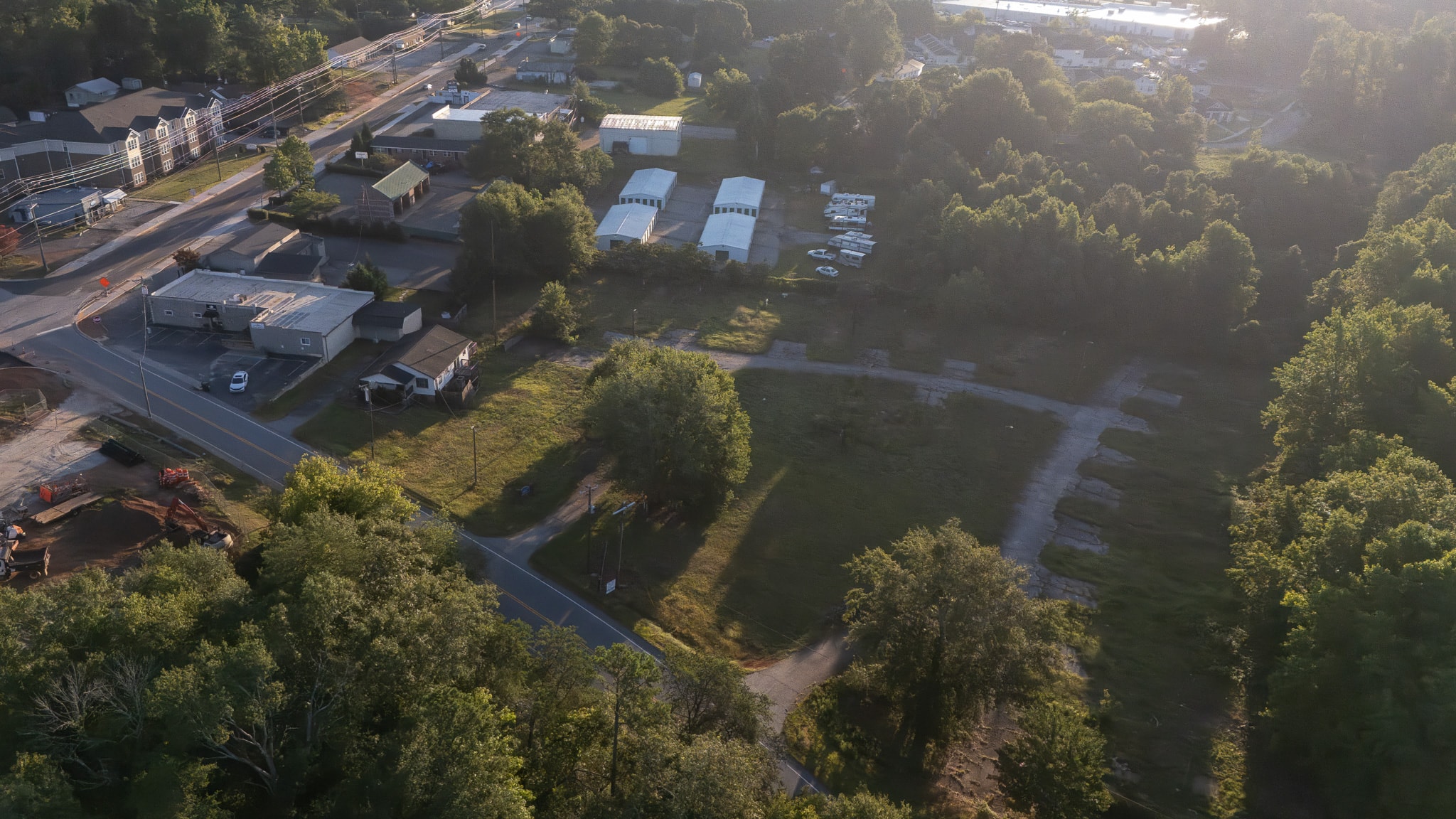 In this image, rolling hills and distant mountain views can be seen from a developing neighborhood in Greenville, South Carolina, showcasing the area's natural beauty and charm. The scene reflects the vibrant community atmosphere, ideal for families looking for best areas to live in Greenville and enjoy local amenities.