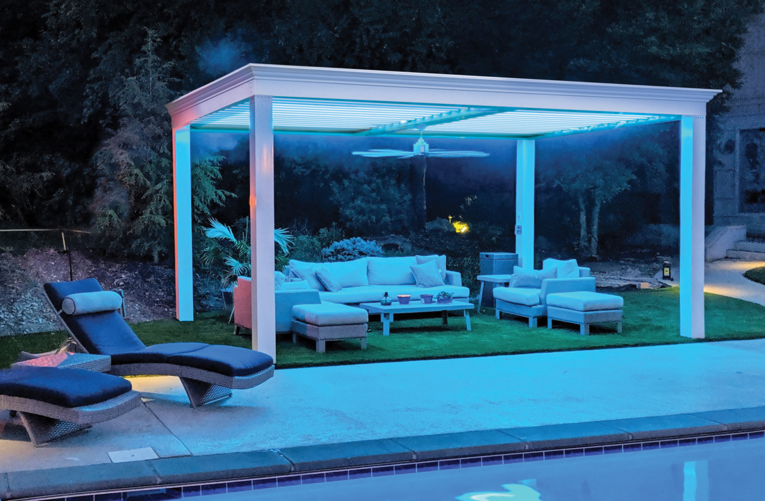 White pergola poolside with seating and lighting.