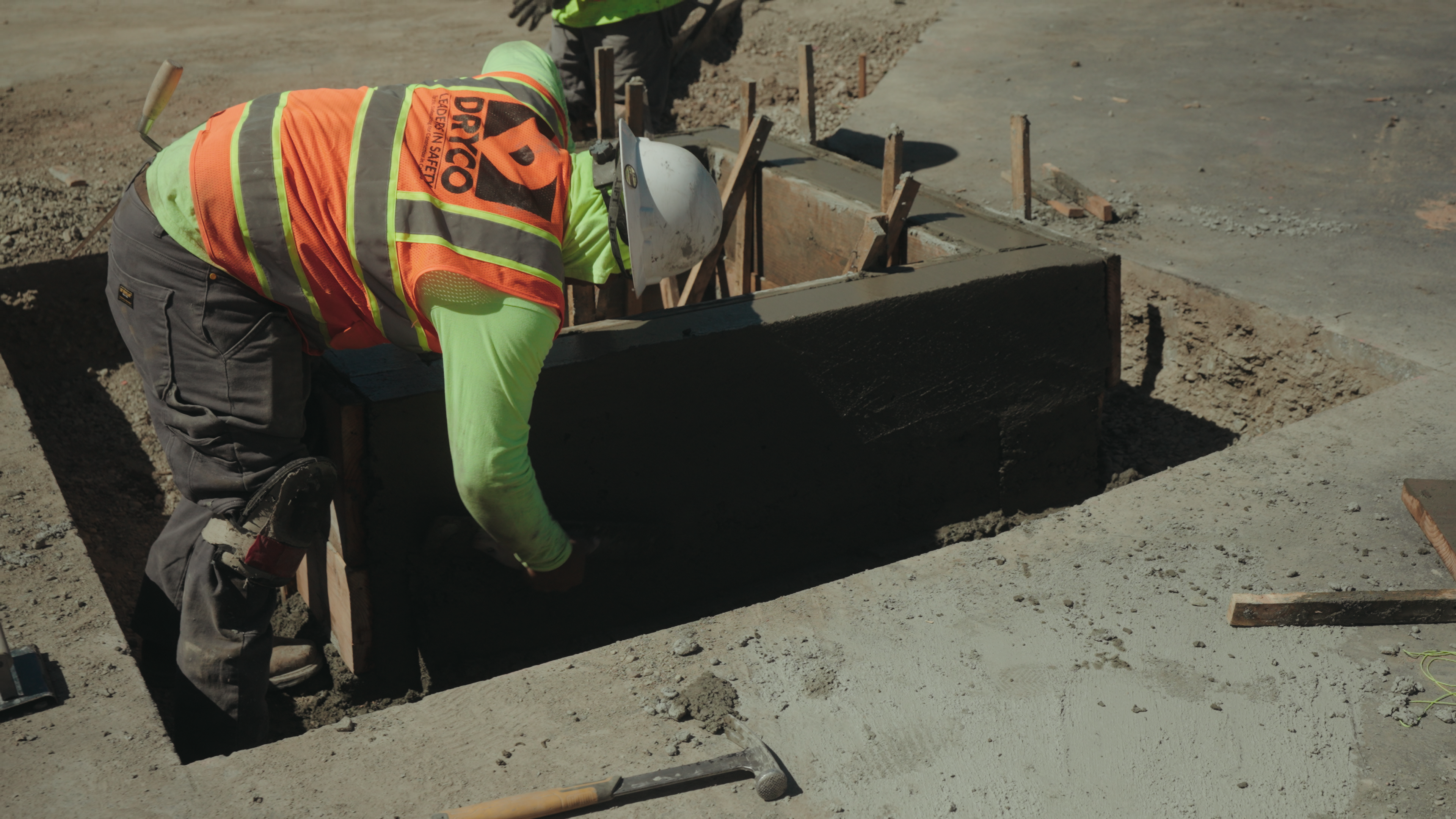 Planning a Large Project with Commercial Paving Contractors? 1 Men in safety gear working on a large paving project.