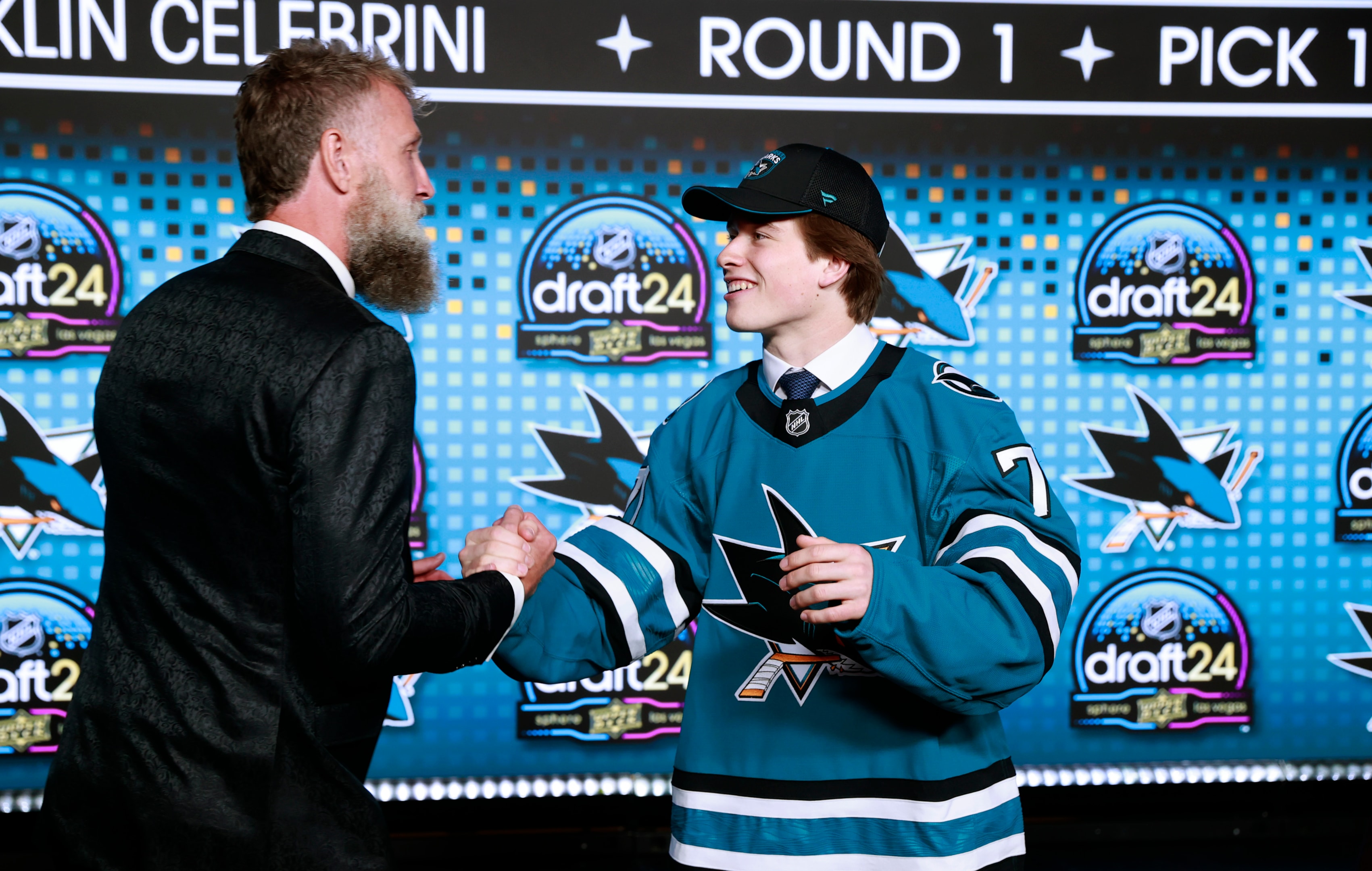 Macklin Celebrini shakes the hand of Joe Thornton onstage after being selected first overall by the San Jose Sharks during the first round of the 2024 Upper Deck NHL Draft at Sphere on June 28, 2024 in Las Vegas, Nevada.