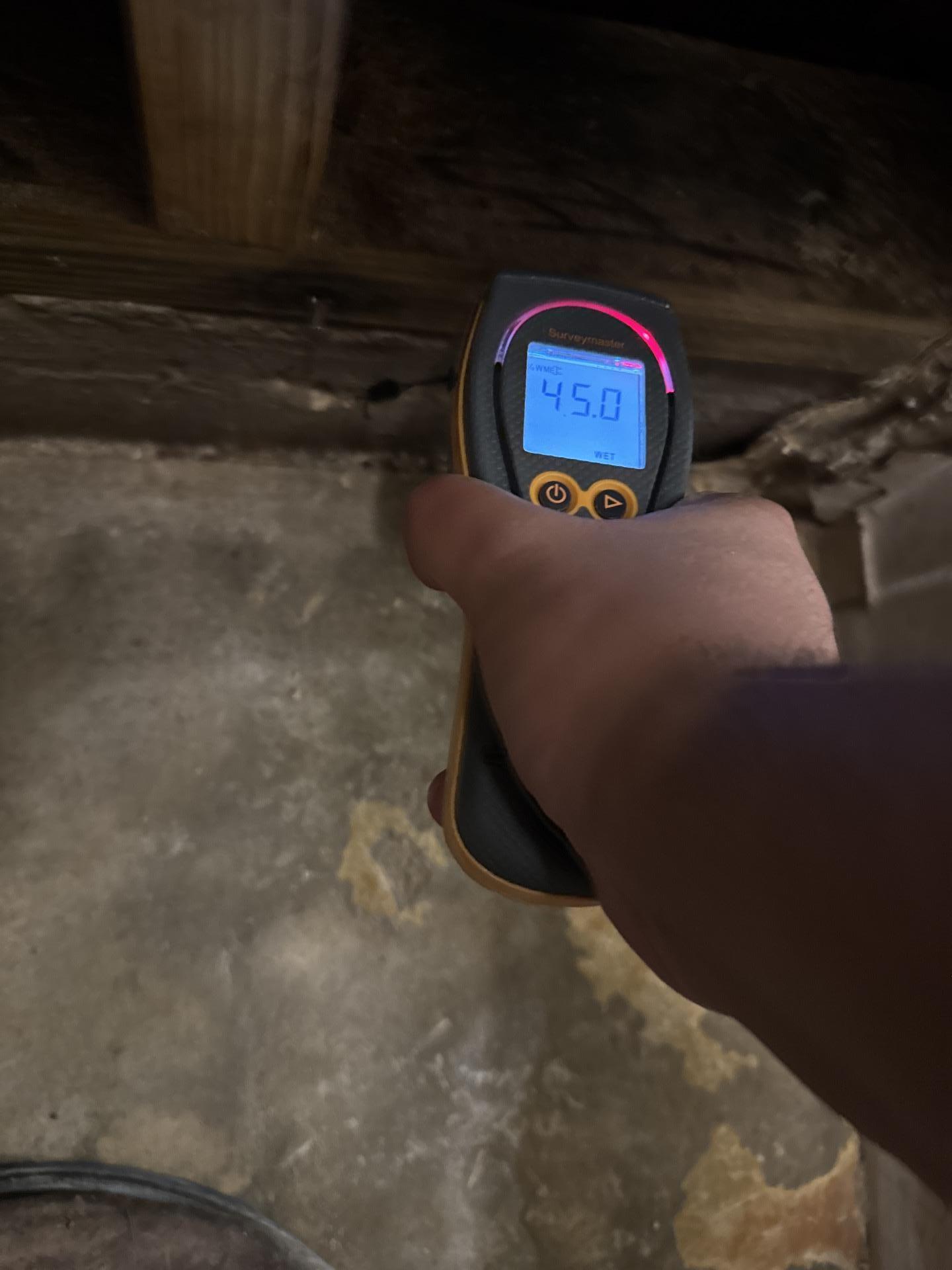 A restoration technician is using professional equipment to check the moisture levels in flooring, ensuring effective water damage restoration and preventing mold growth. This meticulous inspection is a key part of the restoration process to restore the property to its pre-loss condition.
