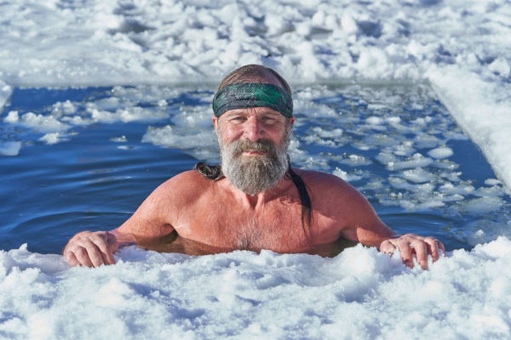 man doing breath exercises in iced water in high mountain