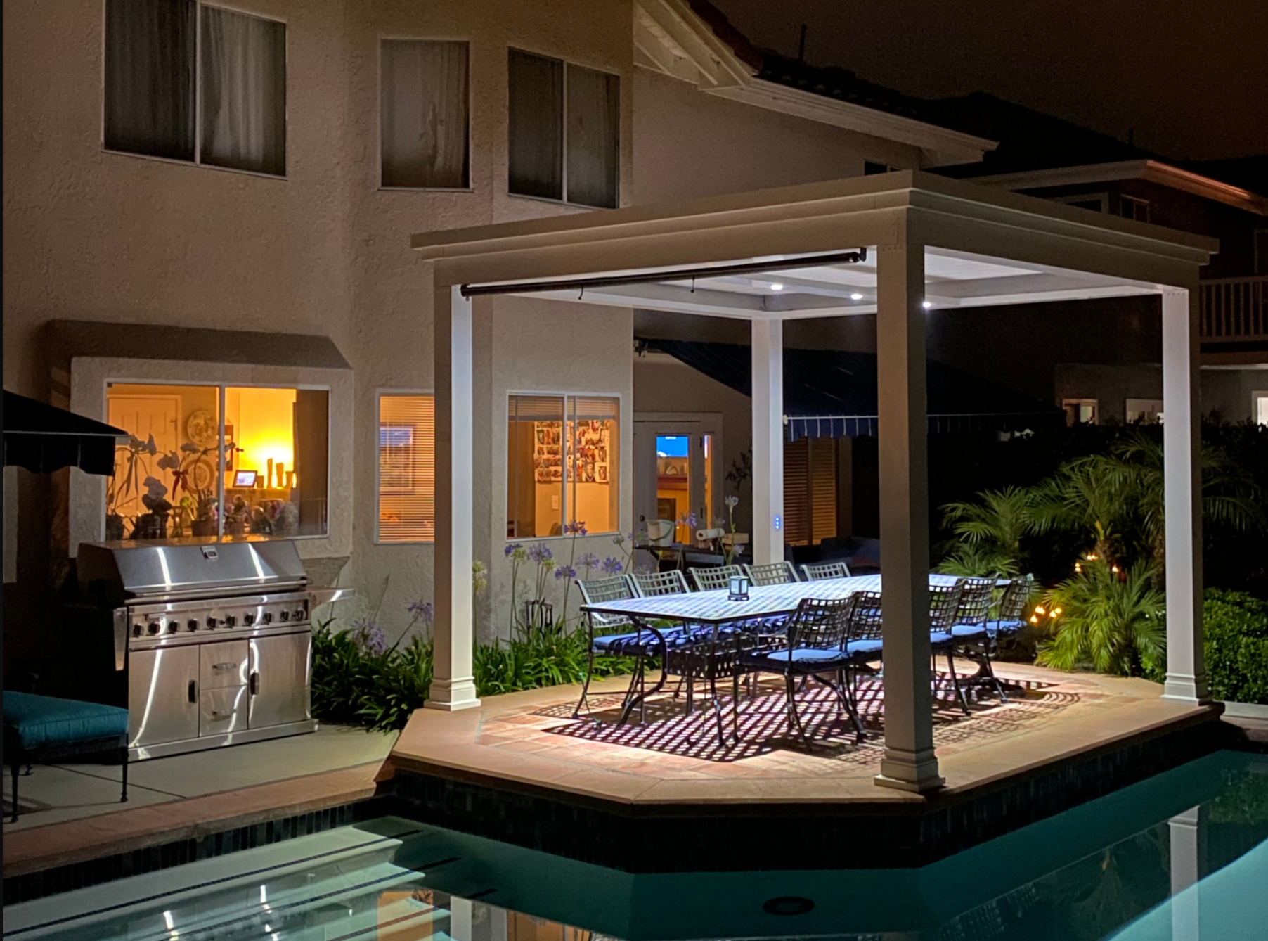 Poolside pergola provides lighting and seating after a latenight swim.