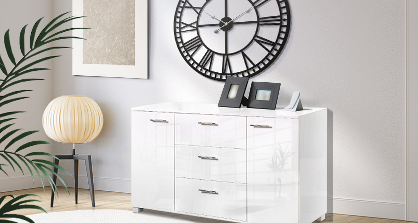 An Artiss white high-gloss sideboard paired with an Artiss black metal wall clock. The contrasting shades create a striking look that is sure to generate conversation.