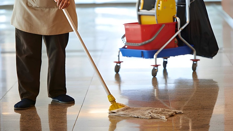 cleaner with mop cleaning hall floor
