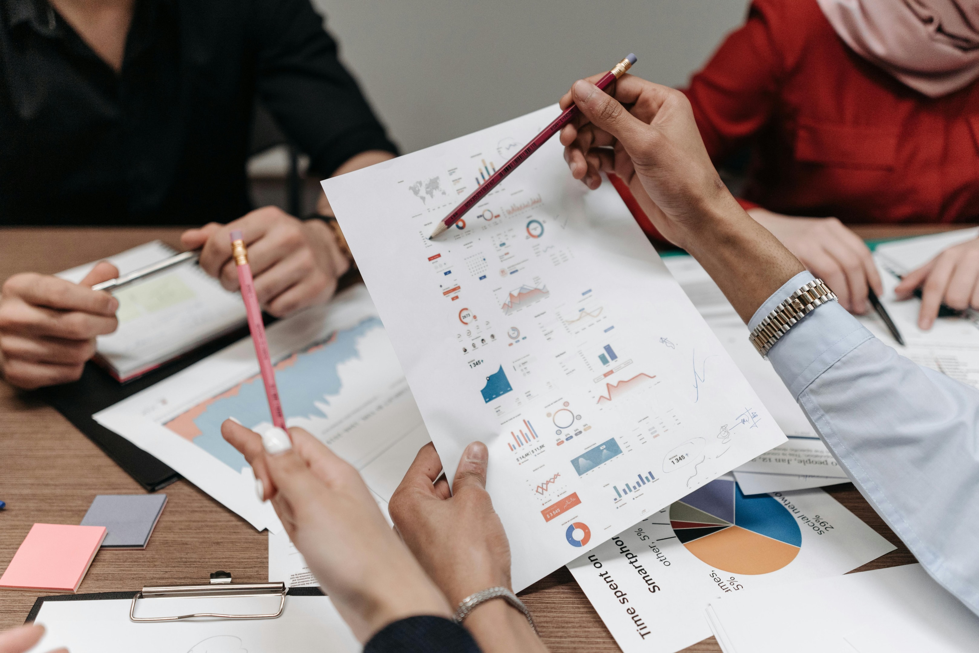 Real estate investing team looks over analytics from direct mail campaign. 