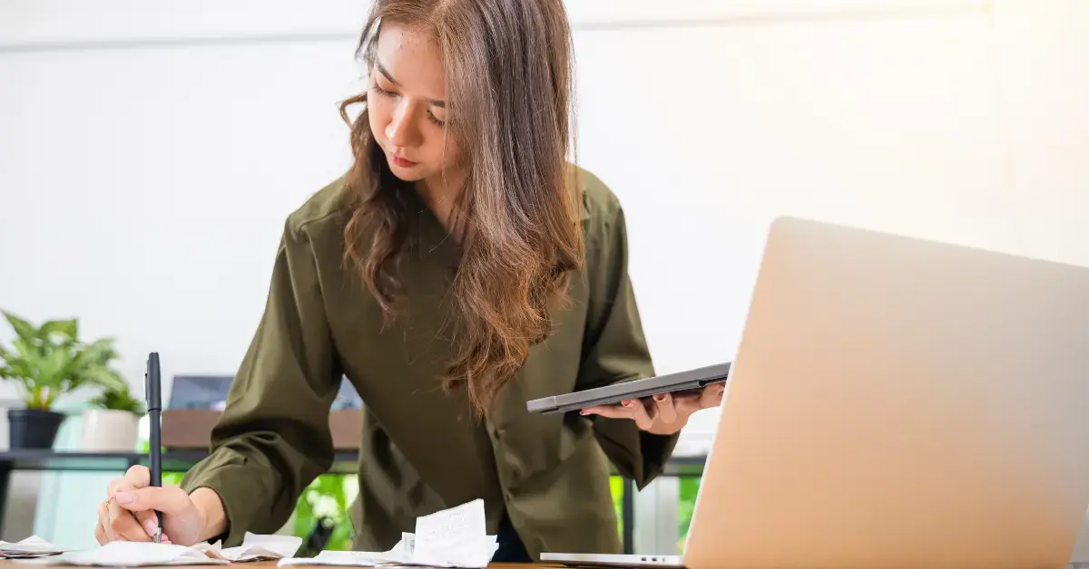 Woman preparing records and Form 12153 to respond to IRS letter 1058.