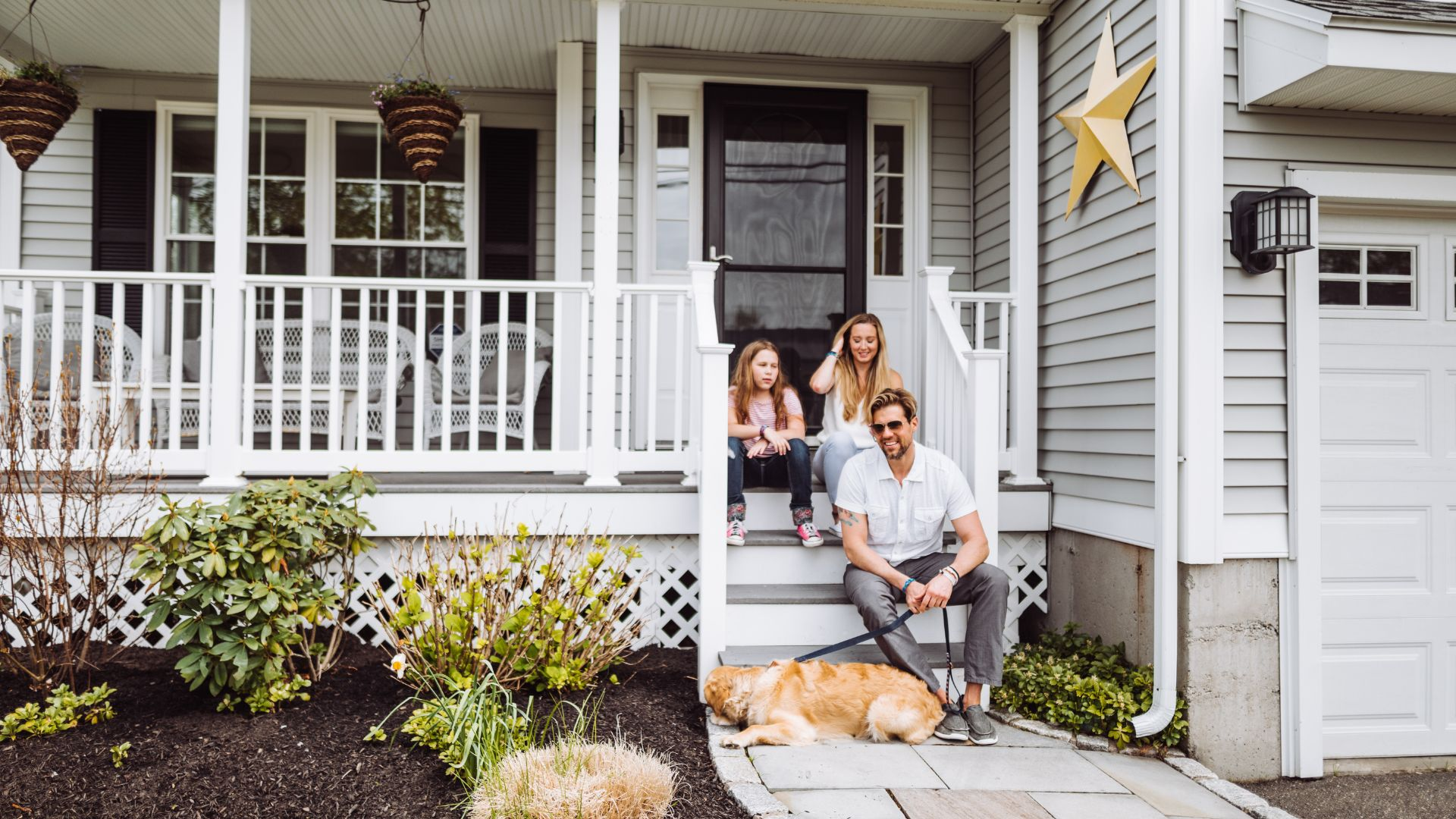 An image of a family in front of their home.