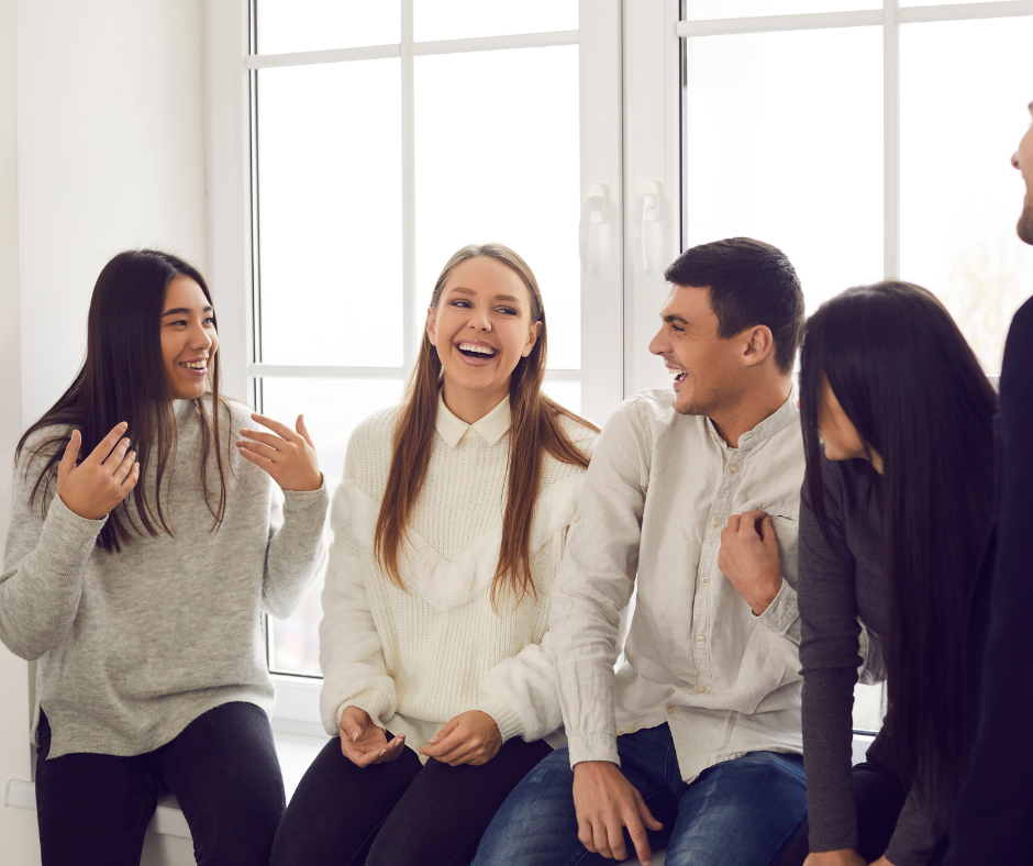 An image of a group of friends laughing and enjoying each other's company, representing the importance of a supportive network during personality changes after getting sober.
